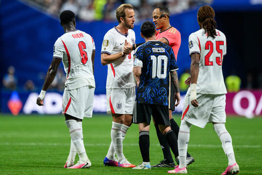 Harry Kane of England and Lionel Messi of Argentina with