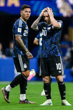 Enzo Fernandez and Lionel Messi of Argentina look dejected
