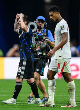 Lionel Messi of Argentina celebrates as Jude Bellingham of