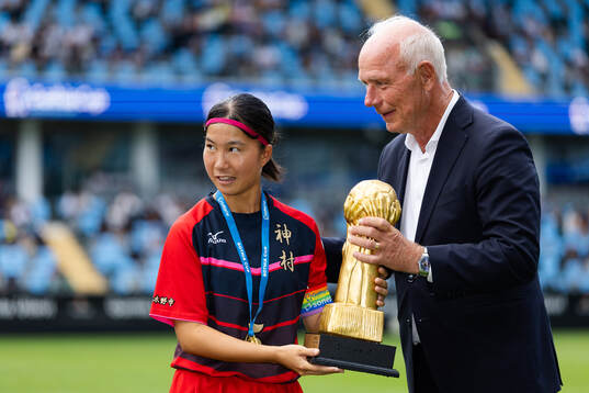 Kamimura Gakuens lagkapten tar emot pokalen från Gothia