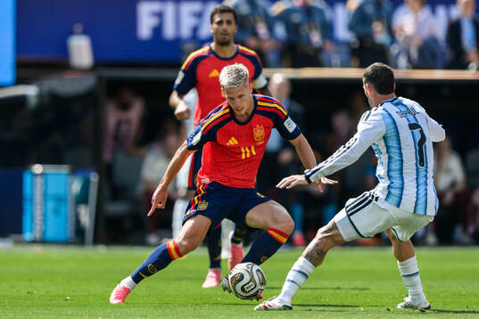 Dani Olmo of Spain and Rodrigo De Paul of Argentina
