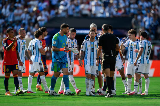 goalkeeper Unai Simon of Spain and Lionel Messi of
