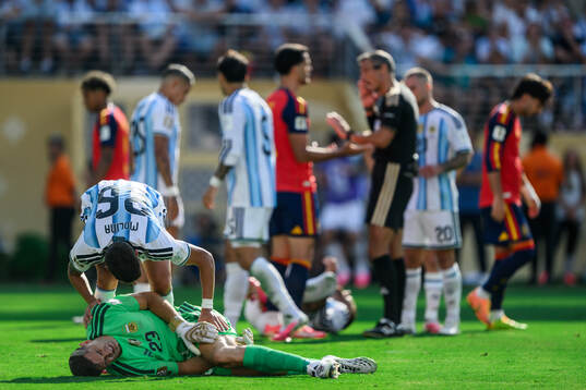 goalkeeper Emiliano Martinez and Nahuel Molina of Argentina