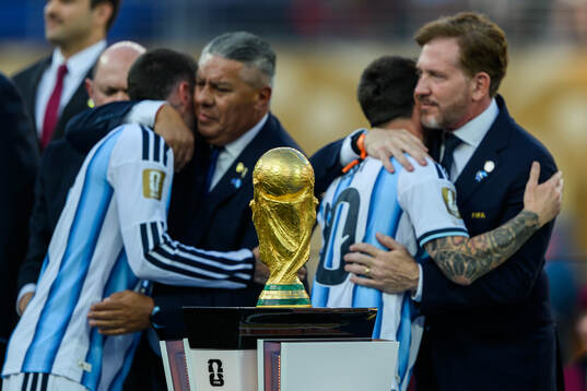 Rodrigo De Paul and Lionel Messi of Argentina behind the