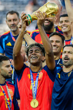 Lamine Yamal of Spain hoists the trophy
