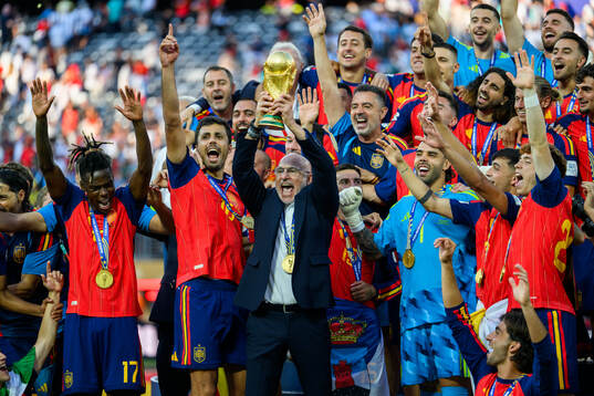 Head coach Luis De La Fuente Castillo of Spain hoists the