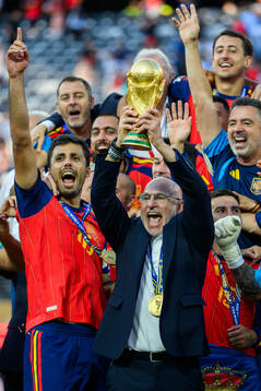Head coach Luis De La Fuente Castillo of Spain hoists the