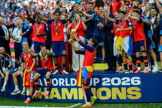 Ferran Torres of Spain hoists the trophy