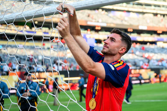 Aymeric Laporte of Spain cuts the net
