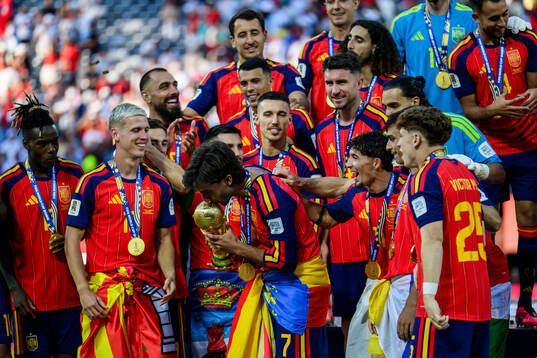 Ferran Torres of Spain kisses the trophy