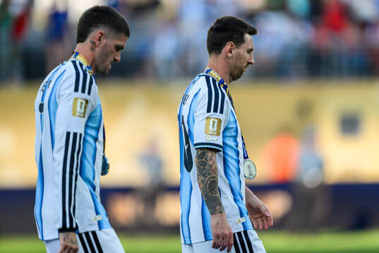 Rodrigo De Paul and Lionel Messi of Argentina look dejected