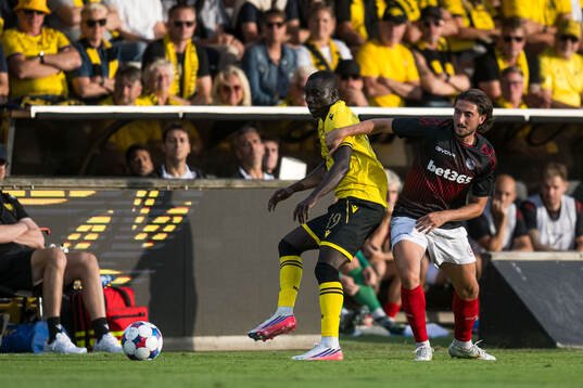Abdoulie Manneh of Mjällby and Alex Mula of Lincoln Red