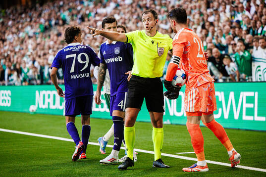 Referee Donald Robertson and goalkeeper Colin Coosemans of