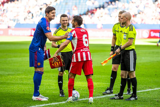 Harry Maguire of Manchester United and Koke of Atletico de