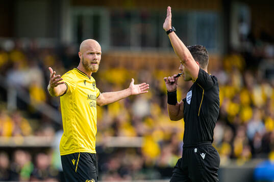 Viktor Gustafson of Mjällby and Referee Nicholas Walsh