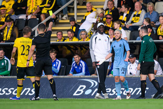 Cristian Martinez of Slovan Bratislava receiving a yellow
