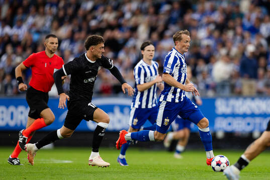 Mathias Delorge of Gent and Sam Larsson of IFK Göteborg