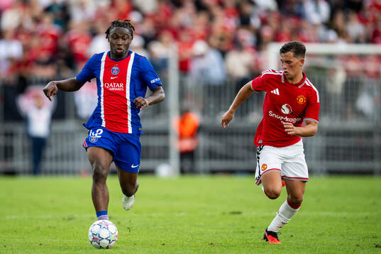 Boly of Paris Saint-Germain and Shea Lacey of Manchester