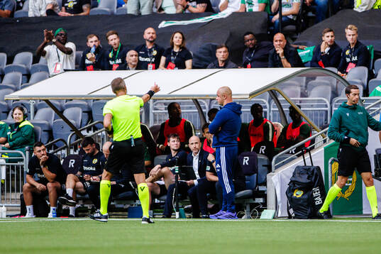 Coach Dawid Kroczek of Rakow receives a yellow card