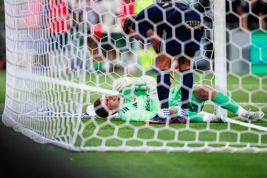 goalkeeper Kacper Trelowski of Rakow in pain