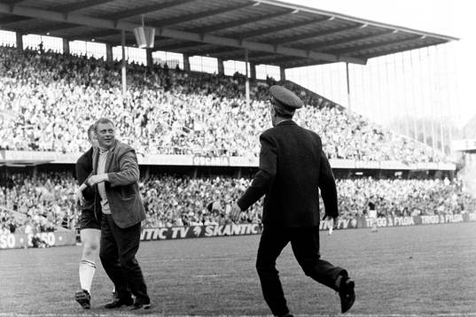 En supporter har tagit sig in på planen och är framme hos