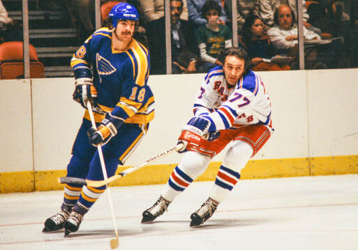 Phil Esposito of New York Rangers (R) against Harvey