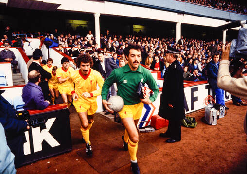 Bruce Grobbelaar and Terry McDermott leads Liverpool out at