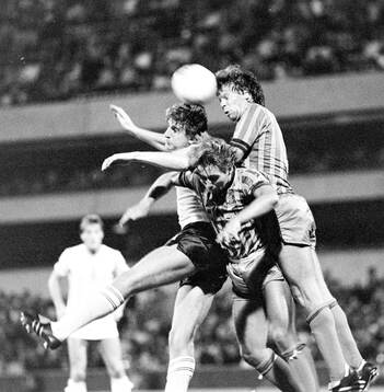 Mark Falco of Tottenham in an air duel