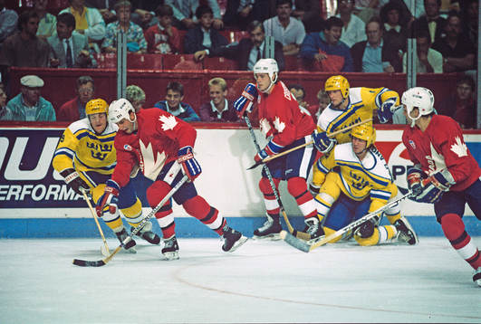 Brent Sutter carries the puck as Sweden's #19 Peter