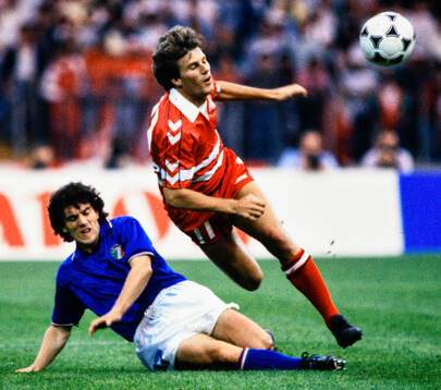 Denmarks Michael Laudrup is tackled by Italys Roberto