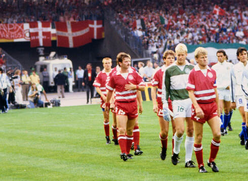 Denmark captain Morten Olsen leads his team out to the pitch