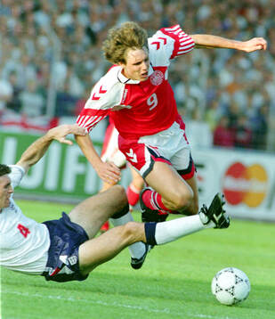 Denmarks Flemming Povlsen is tackled by Englands Martin