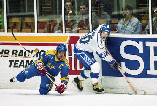 Tommy Sjödin på knä i en kamp om pucken