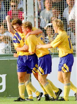 Swedens goalscorer Jan Eriksson (2nd from R) celebrates his