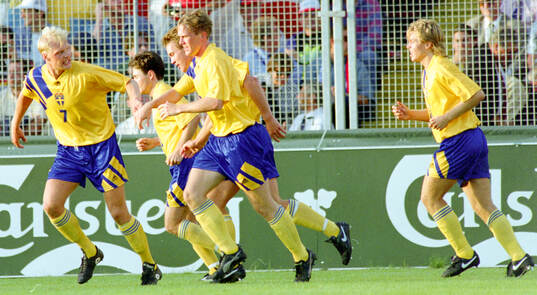 Swedens goalscorer Jan Eriksson (2nd from R) celebrates his