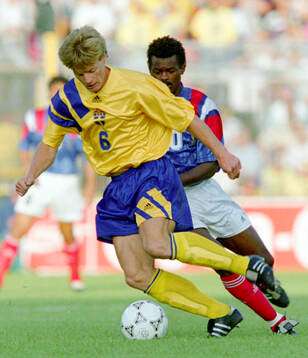 Stefan Schwarz of Sweden shields the ball in front of