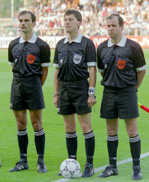 Referee Gerard Biguet of France flanked by the linesmen