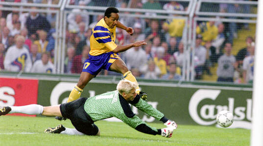 Swedens Martin Dahlin against Denmarks goalkeeper Peter
