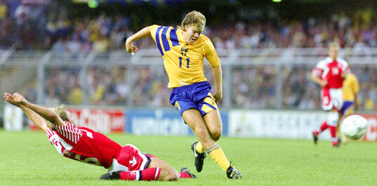 Swedens Tomas Brolin shoots at goal, left Denmarks Kim