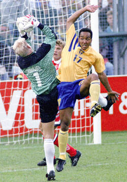 Swedens Martin Dahlin against Denmarks goalkeeper Peter