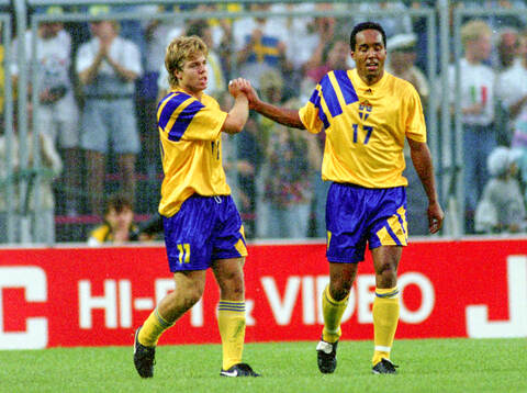 Swedens goalscorer Tomas Brolin (L) celebrates with Martin