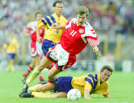 Denmarks Brian Laudrup is tackled by Swedens Patrik