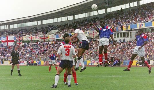 France’s Jocelyn Angloma heads the ball