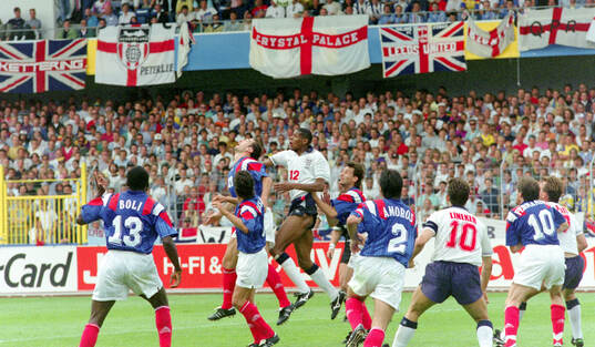 France’s Eric Cantona in an air duel against Englands
