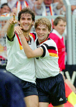 Germanys Karl-Heinz Riedle (L) celebrates his 1-0 goal with