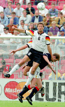 Germanys Guido Buchwald in aerial duel against Scotlands