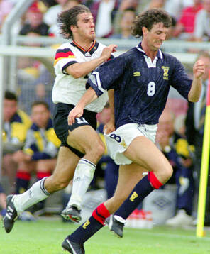 Germanys Karl-Heinz Riedle (L) against Scotlands Dave Mc