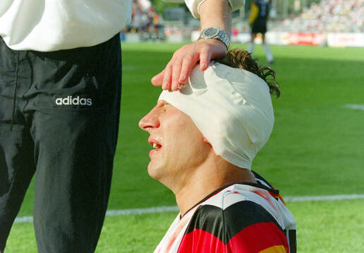 Germanys Guido Buchwald injured in the head