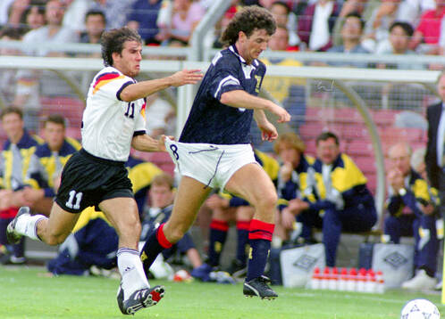 Germanys Karl-Heinz Riedle (L) against Scotlands Dave Mc