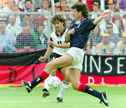 Germanys Karl-Heinz Riedle (L) against Scotlands Dave